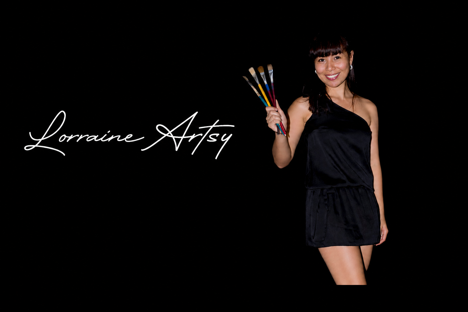 Lorraine Artsy holding paint brushes wearing a black evening dress